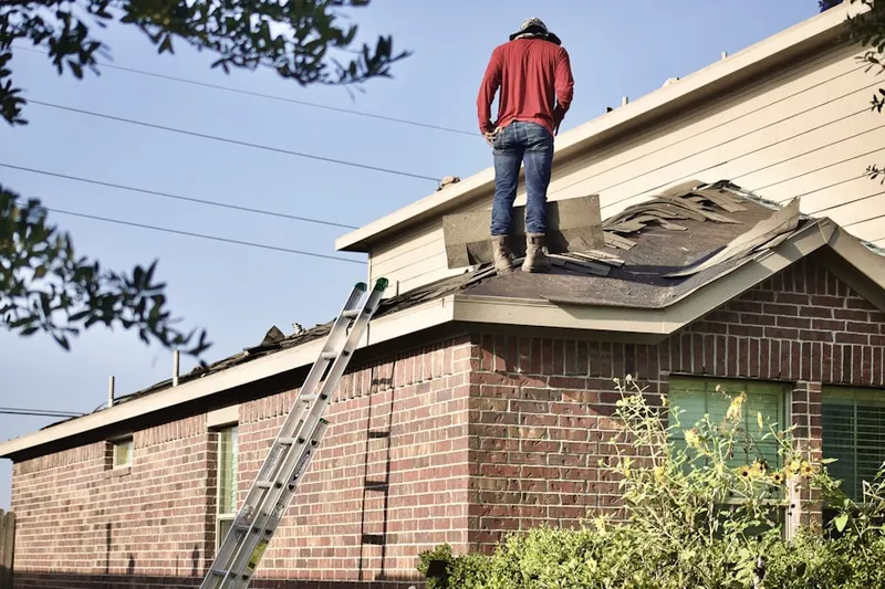 Professional roofer working on a residential roof in Camp Osborne